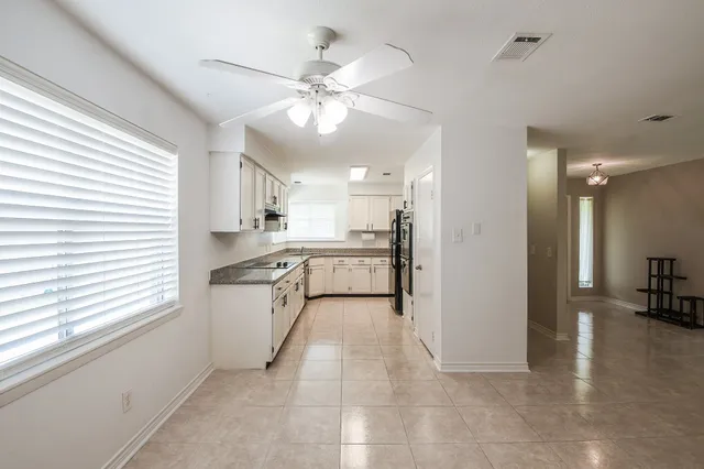 a view of a kitchen with a sink and a window