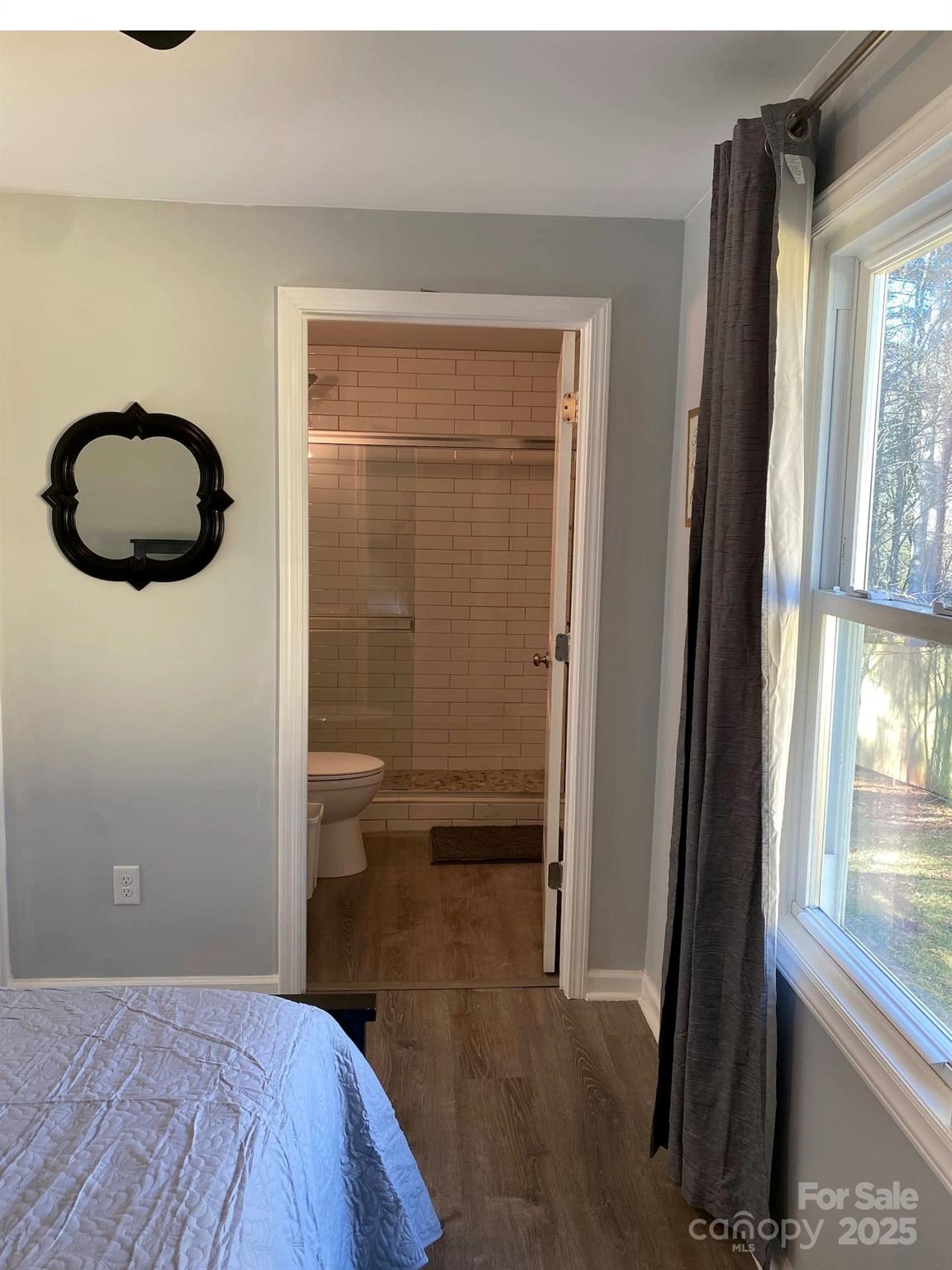 334 Mills Gap Road Asheville, NC 28803 - Photo 12 of 18 a bedroom with a bed and a window