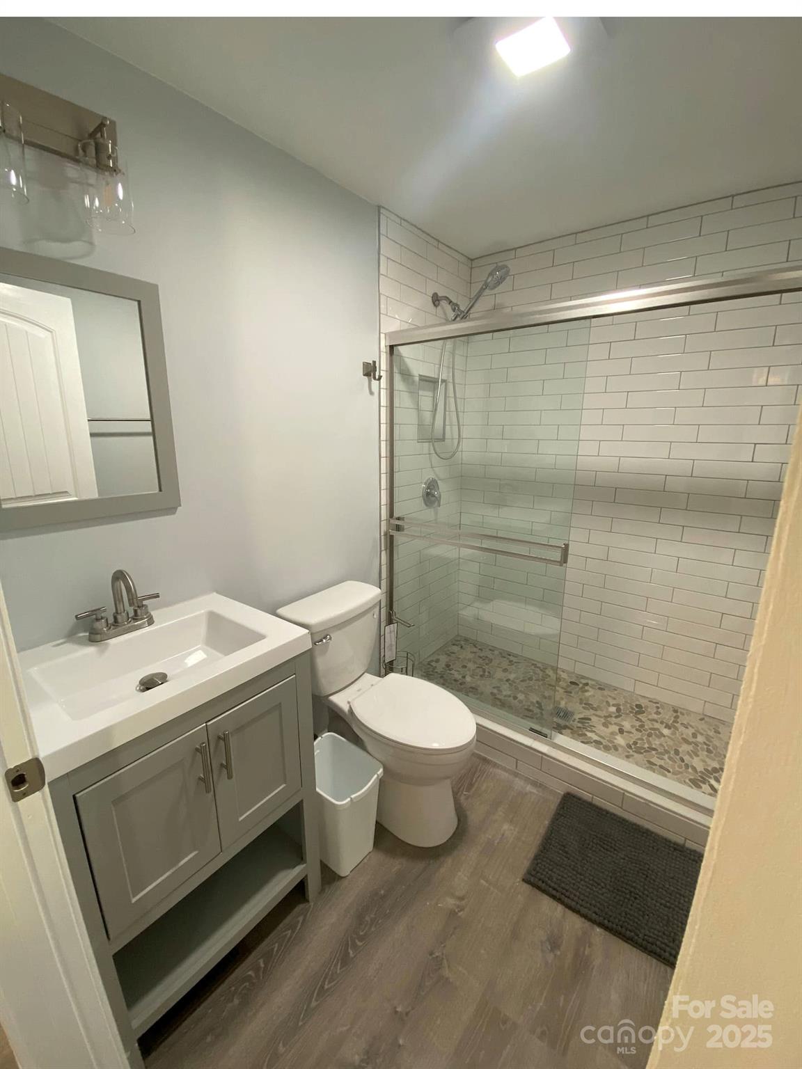334 Mills Gap Road Asheville, NC 28803 - Photo 17 of 18 a bathroom with a sink toilet and shower