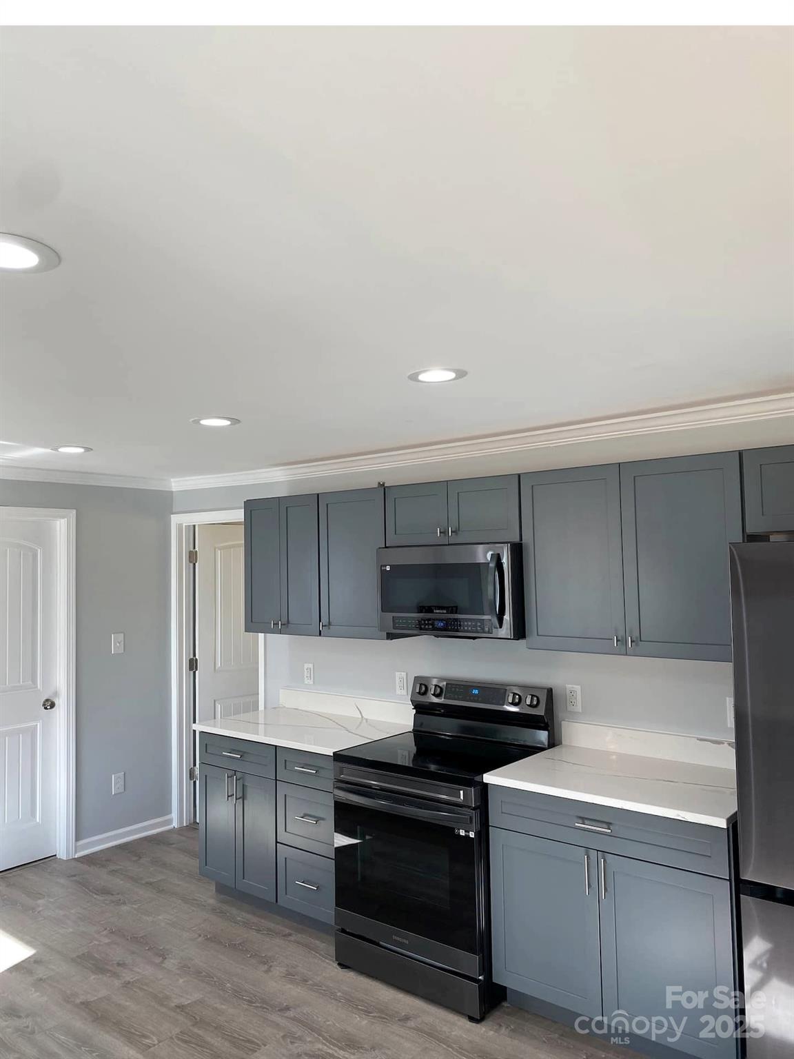 334 Mills Gap Road Asheville, NC 28803 - Photo 8 of 18 a kitchen with granite countertop a refrigerator and a stove top oven