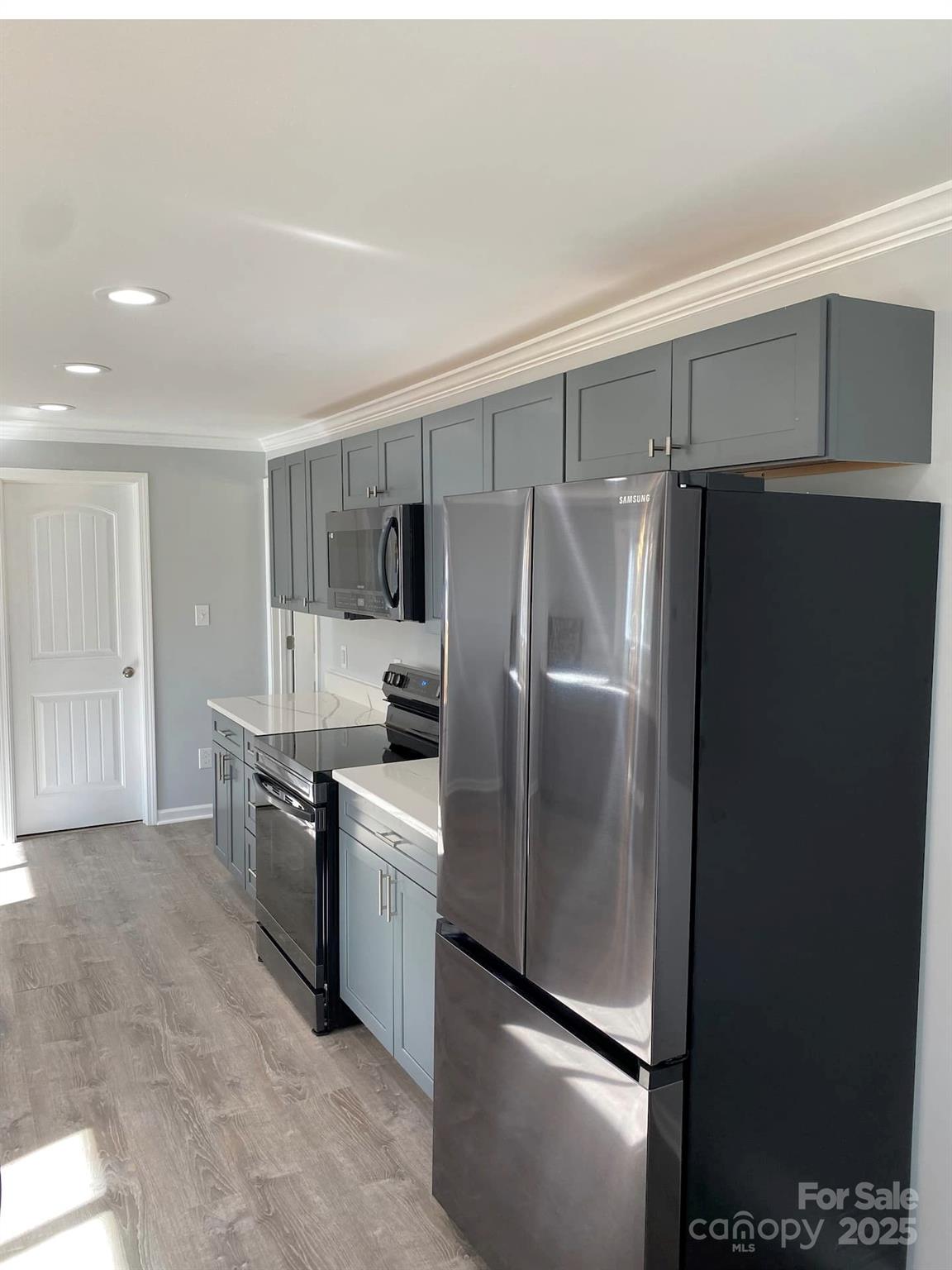 334 Mills Gap Road Asheville, NC 28803 - Photo 9 of 18 a kitchen with stainless steel appliances a refrigerator and a stove top oven