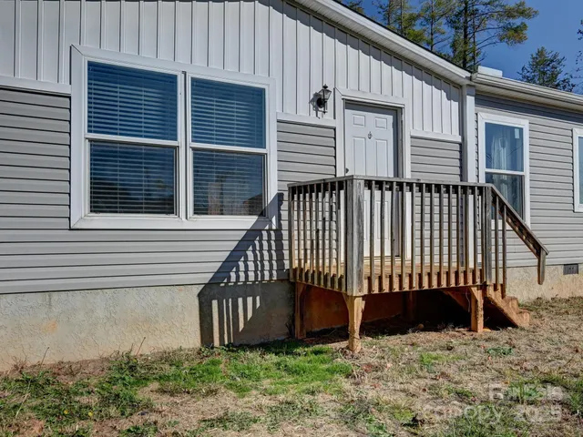 a view of a house with a yard and deck