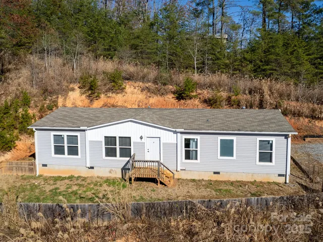 a view of a house with a yard covered in snow