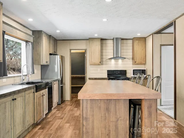 a kitchen with stainless steel appliances a refrigerator sink and cabinets