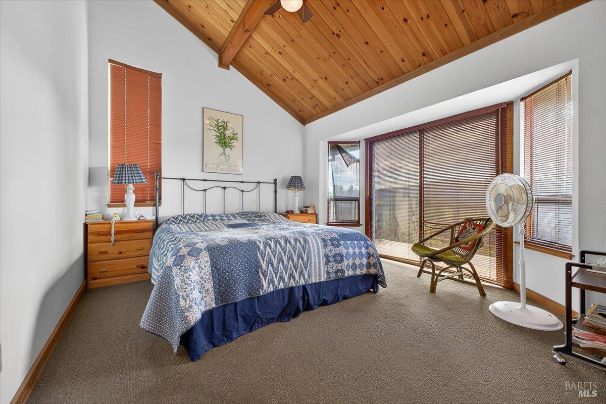 23881 Walling Road Geyserville, CA 95441 - Photo 14 of 40 a bedroom with a bed and large windows