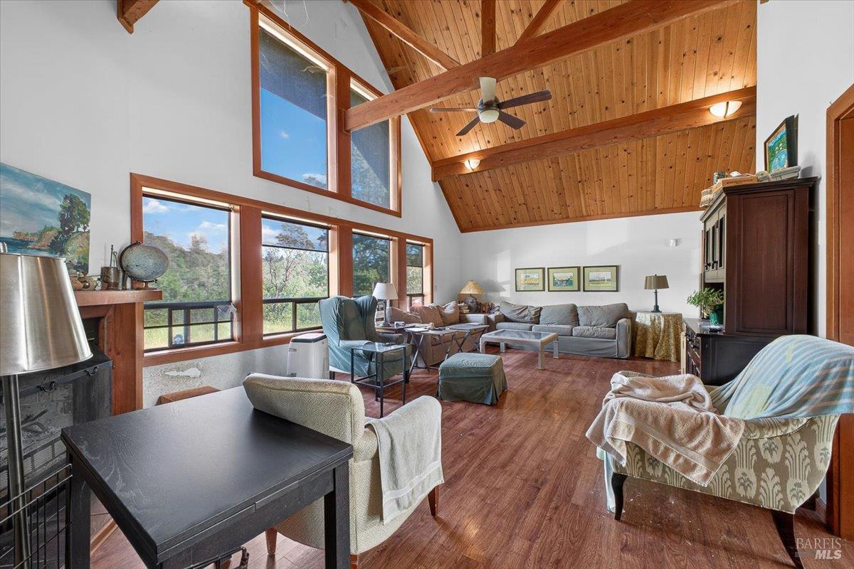 23881 Walling Road Geyserville, CA 95441 - Photo 4 of 40 a living room with furniture a large window and wooden floor