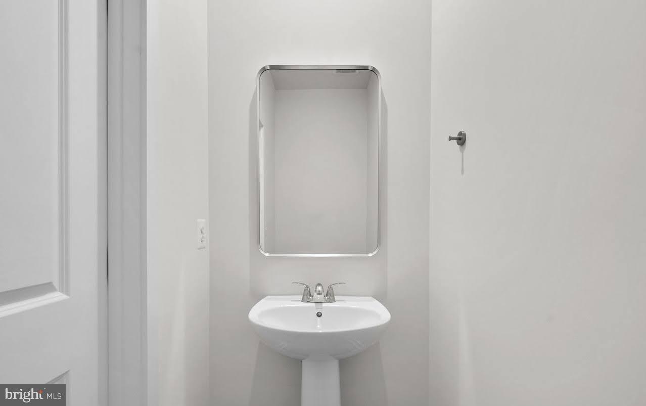 109 Galaxy Place Stephenson, VA 22656 - Photo 14 of 25 a bathroom with a sink and a mirror