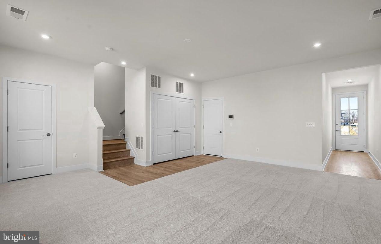 109 Galaxy Place Stephenson, VA 22656 - Photo 20 of 25 a view of an empty room with wooden floor and stairs