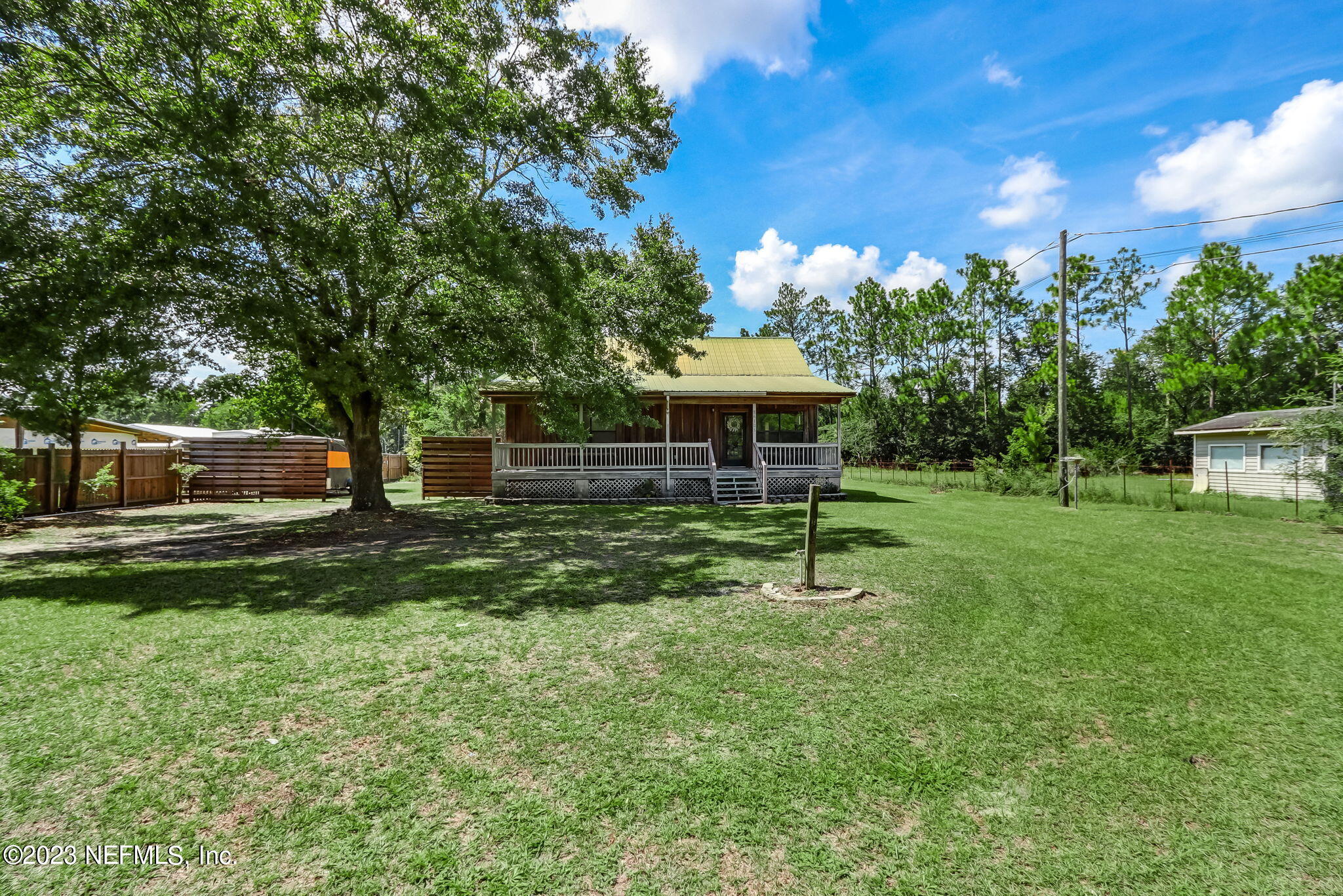 86105 Pages Dairy Road Yulee, FL 32097 - Photo 1 of 39 a table and chairs sitting in the grass