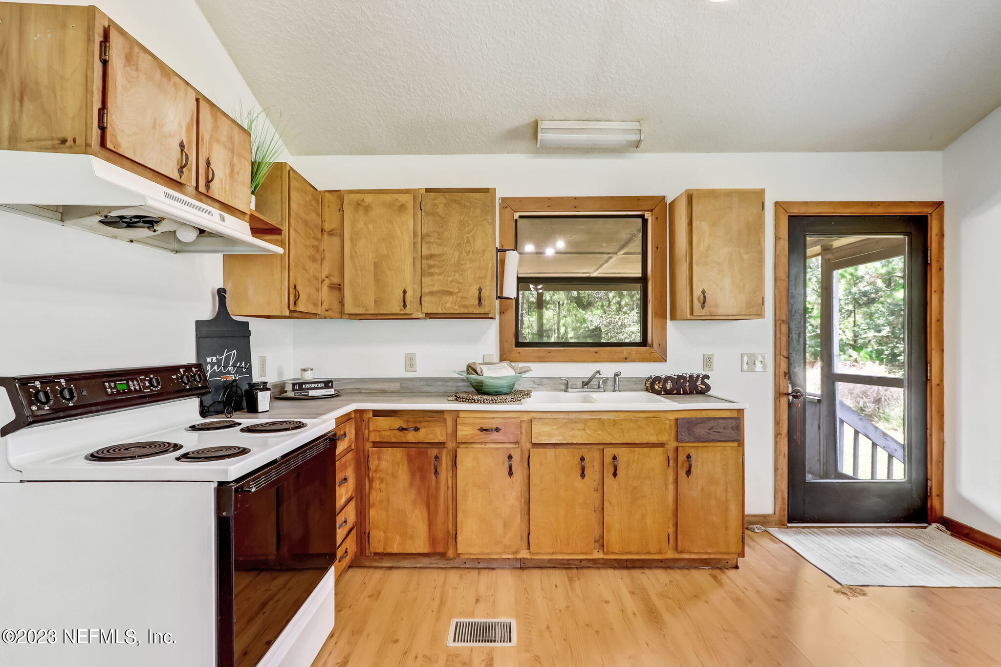 86105 Pages Dairy Road Yulee, FL 32097 - Photo 13 of 39 a kitchen with a sink stove and cabinets