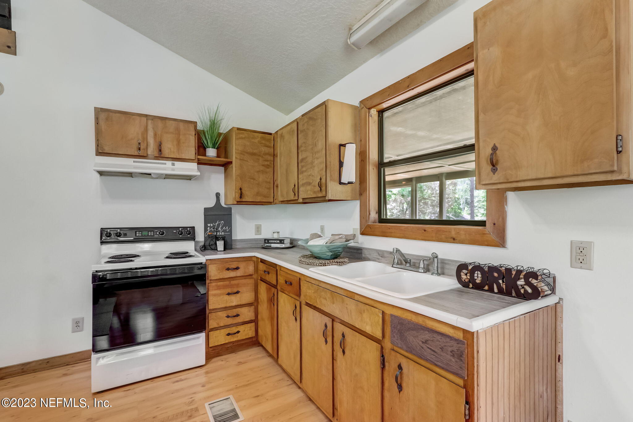 86105 Pages Dairy Road Yulee, FL 32097 - Photo 14 of 39 a kitchen with stainless steel appliances granite countertop a stove a sink and a microwave