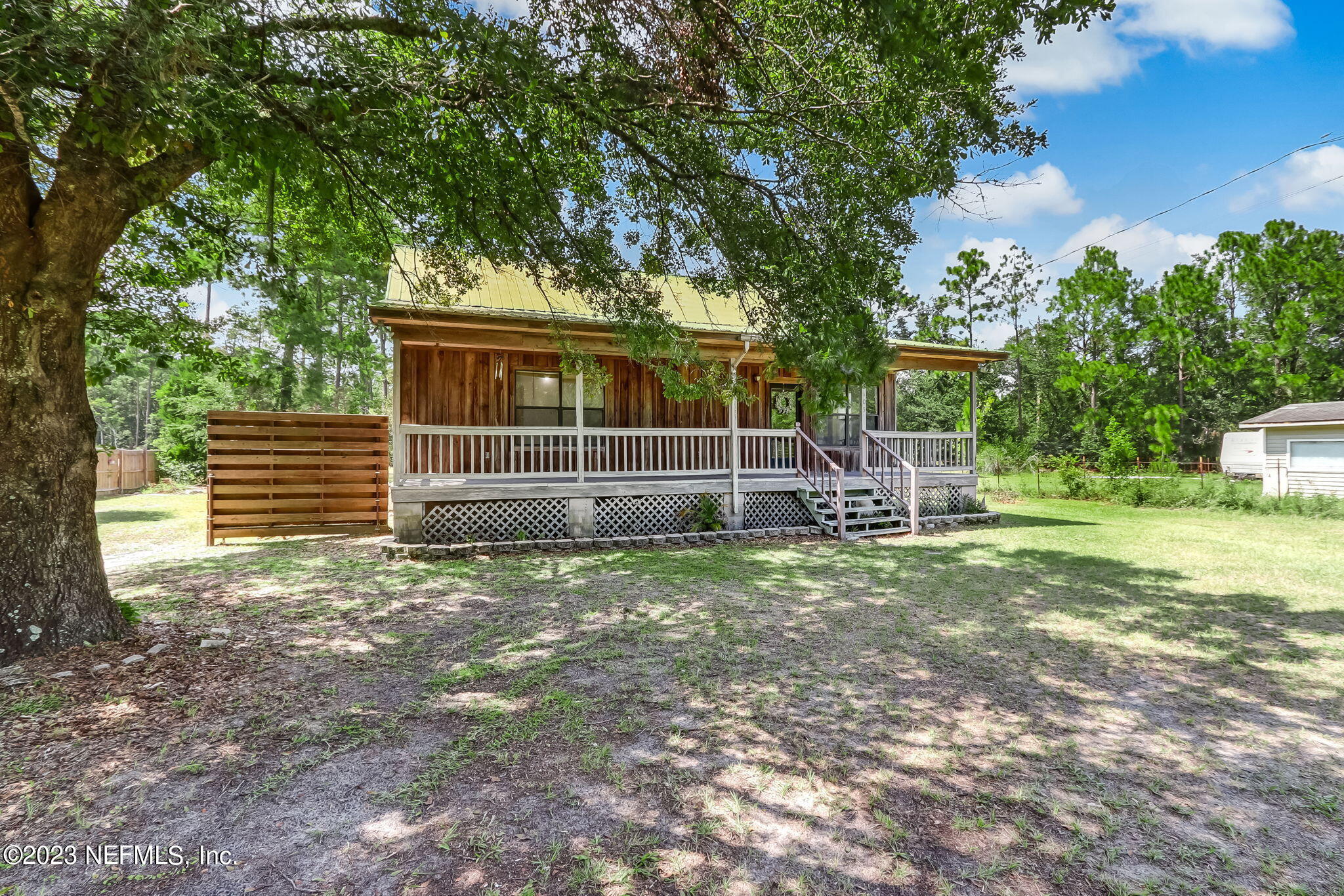 86105 Pages Dairy Road Yulee, FL 32097 - Photo 2 of 39 a view of a house with backyard and a tree
