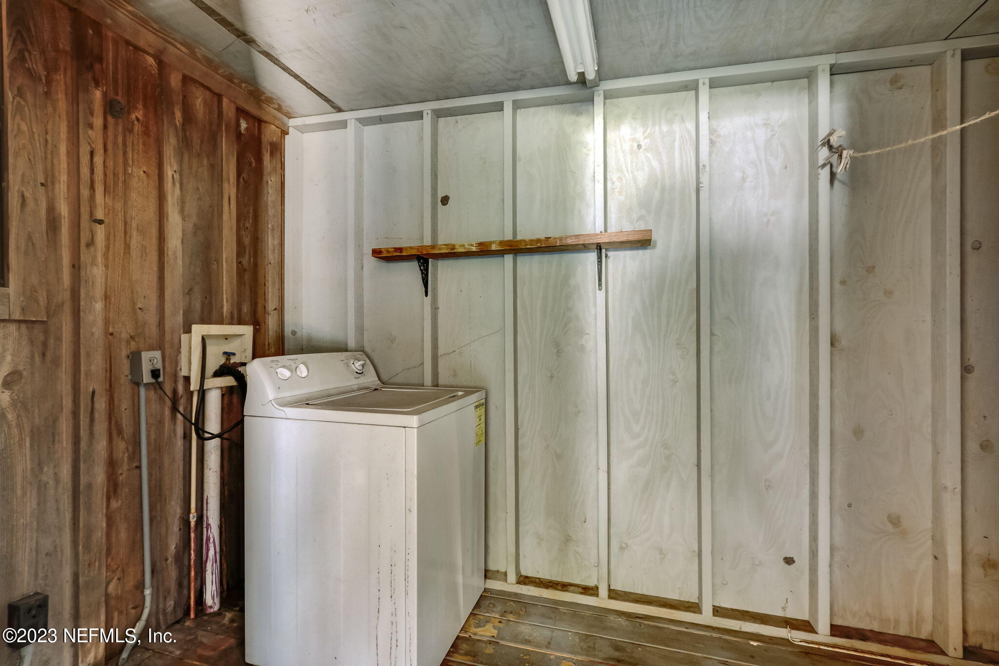 86105 Pages Dairy Road Yulee, FL 32097 - Photo 29 of 39 a view of a storage & utility room with water heater and racks
