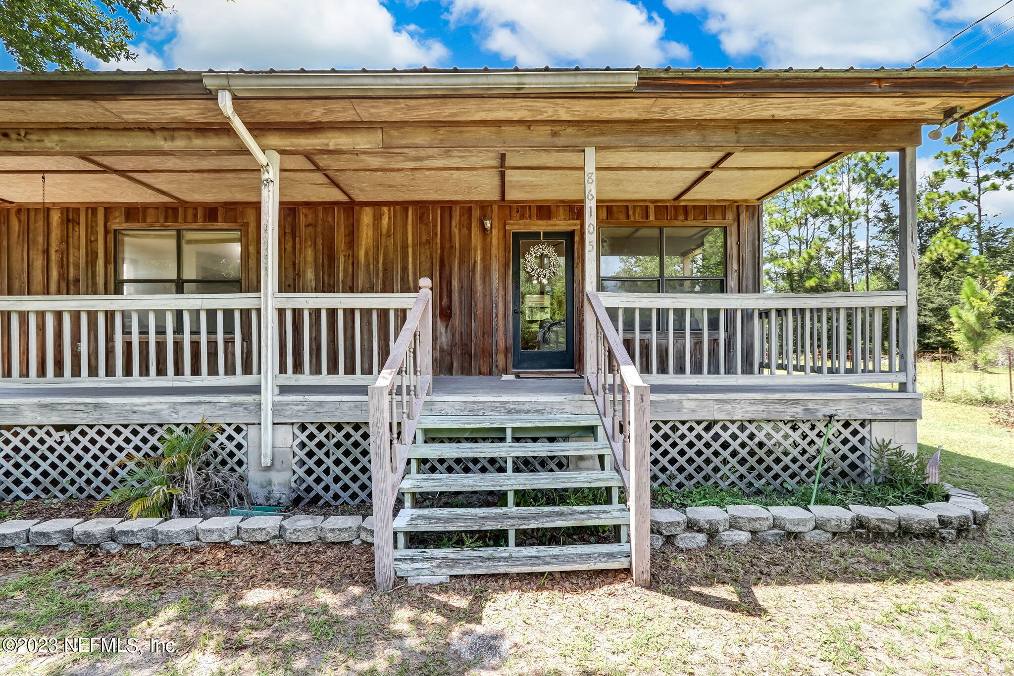 86105 Pages Dairy Road Yulee, FL 32097 - Photo 3 of 39 a view of porch with wooden fence