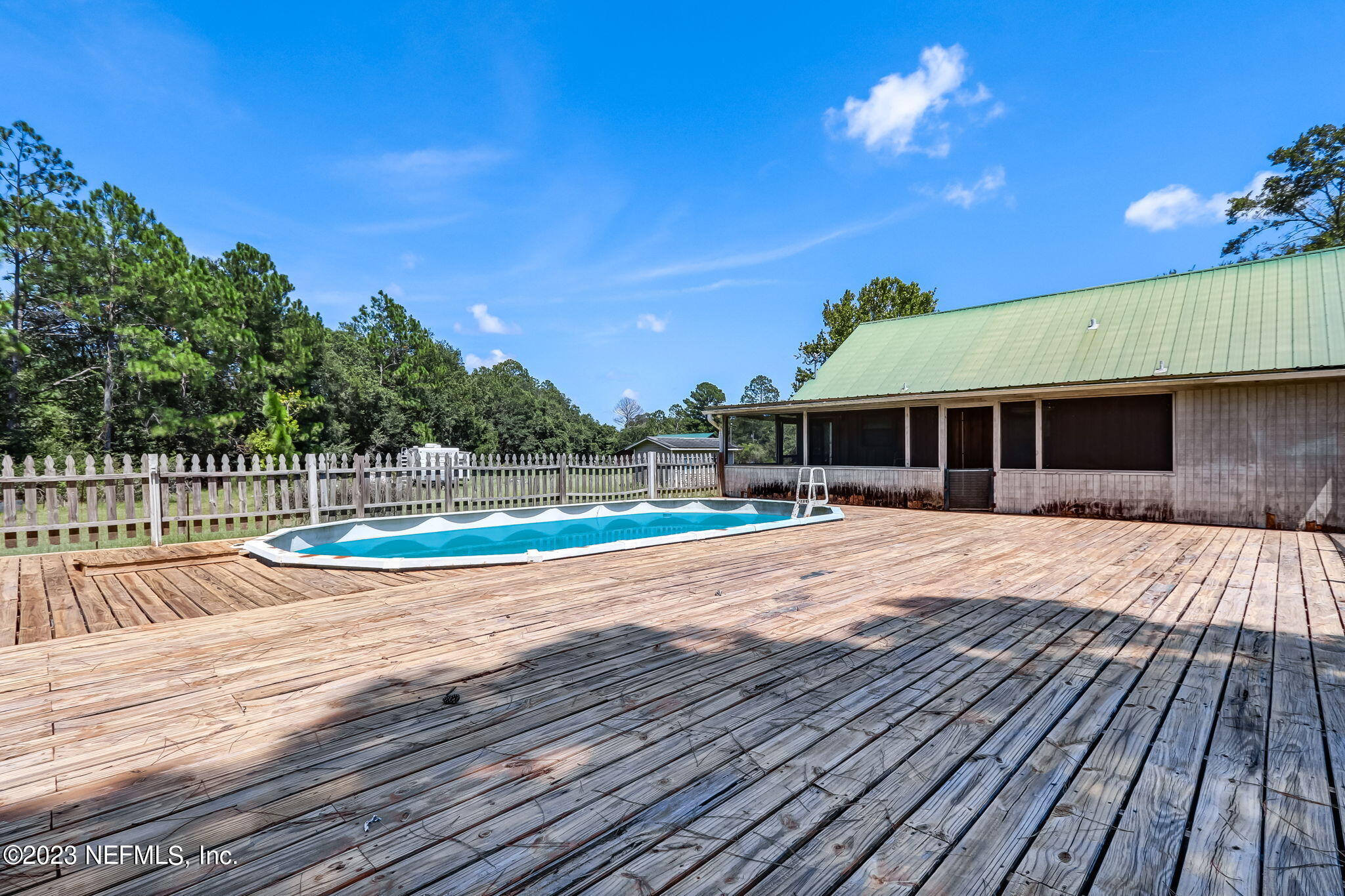 86105 Pages Dairy Road Yulee, FL 32097 - Photo 32 of 39 a view of a house with wooden floor and a yard