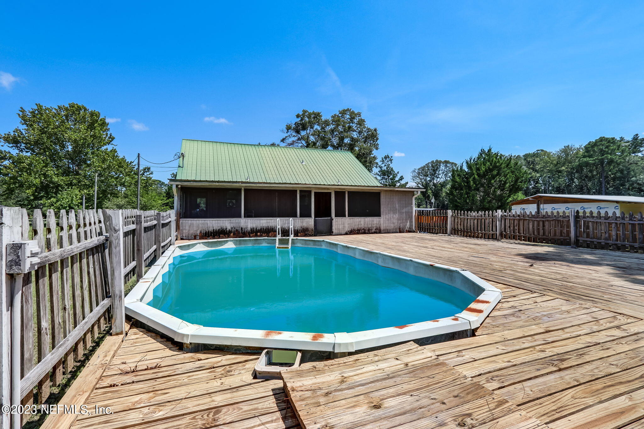 86105 Pages Dairy Road Yulee, FL 32097 - Photo 34 of 39 a view of a house with swimming pool and porch