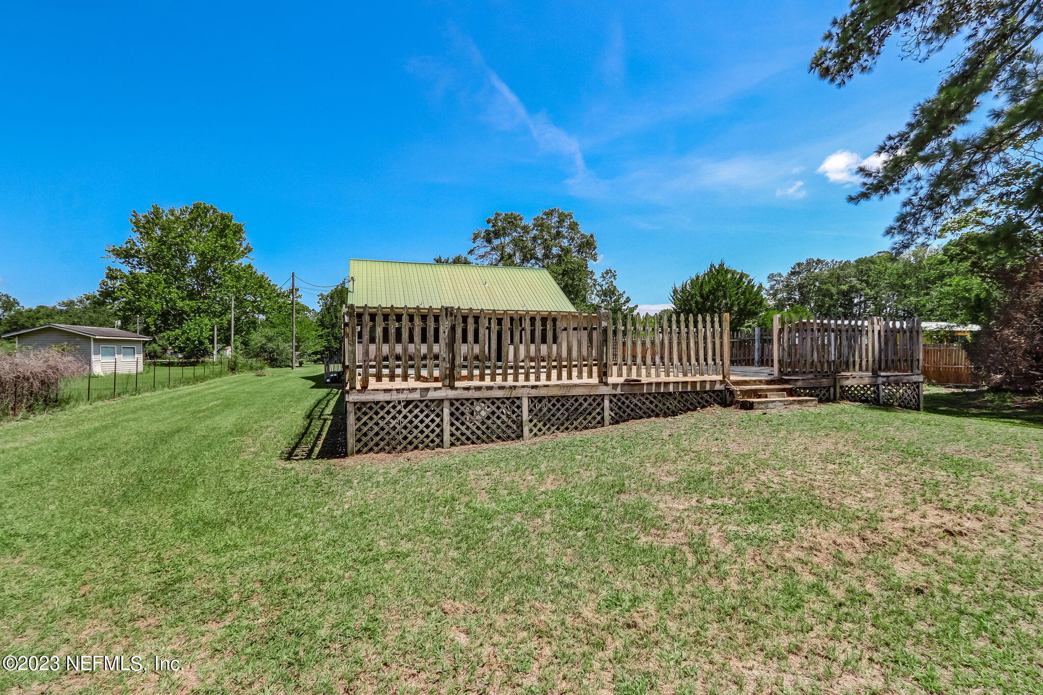 86105 Pages Dairy Road Yulee, FL 32097 - Photo 36 of 39 a view of a garden with a bench in the garden