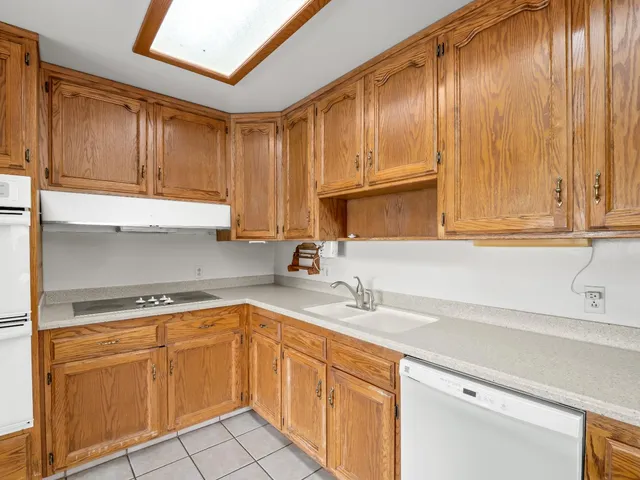 a kitchen with a sink cabinets and appliances