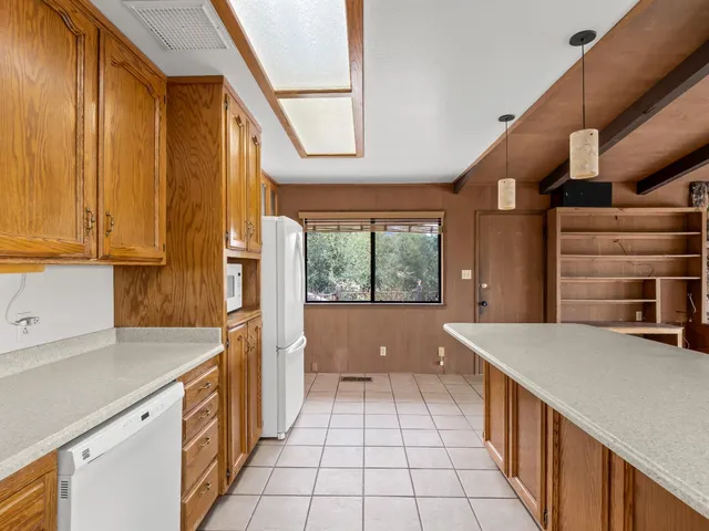 a view of a kitchen with furniture and staircase
