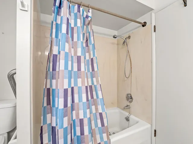 a bathroom with a bathtub and shower