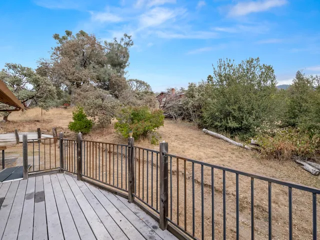 a balcony with wooden floor and fence