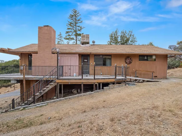 a view of a house with a backyard and windows