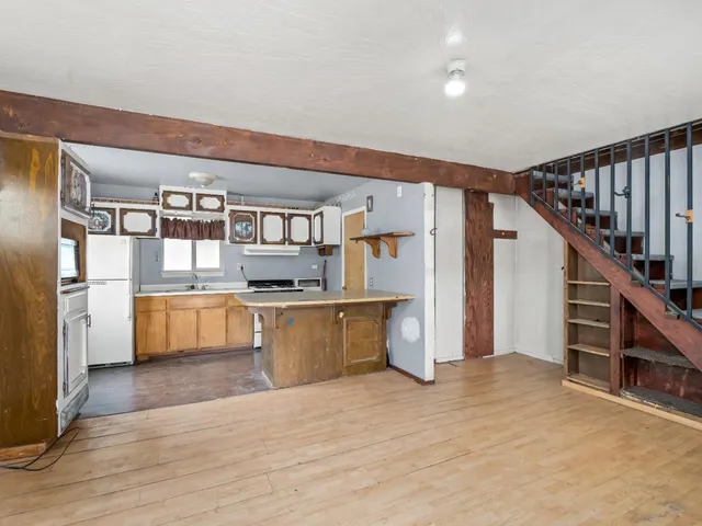 a kitchen with stainless steel appliances kitchen island wooden cabinets and granite counter tops