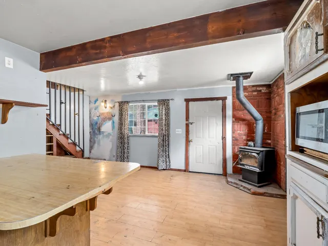a view of a kitchen with a sink and refrigerator