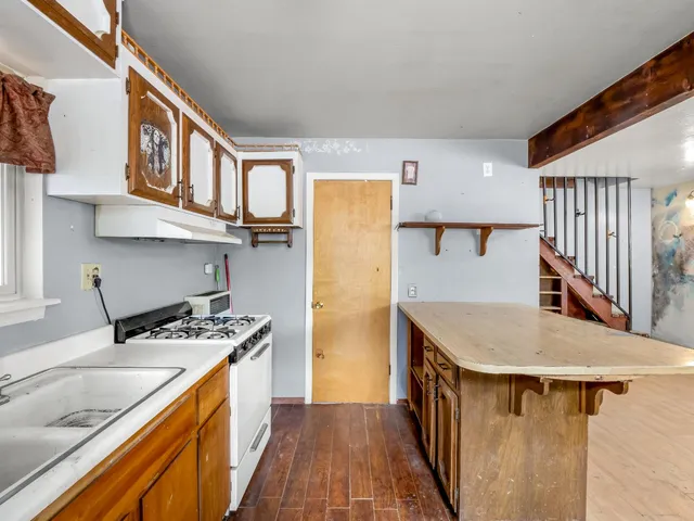 a kitchen with stainless steel appliances granite countertop a sink stove and cabinets