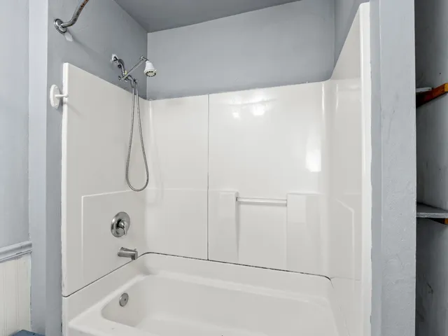 a bathroom with a bathtub and a shower