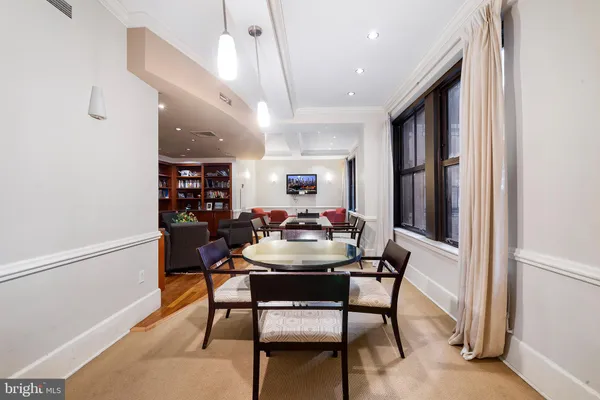 a living room with furniture a flat screen tv and book shelf