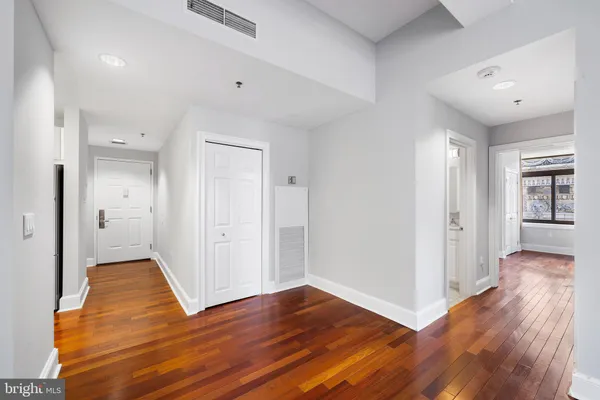 a view of a hallway with wooden floor