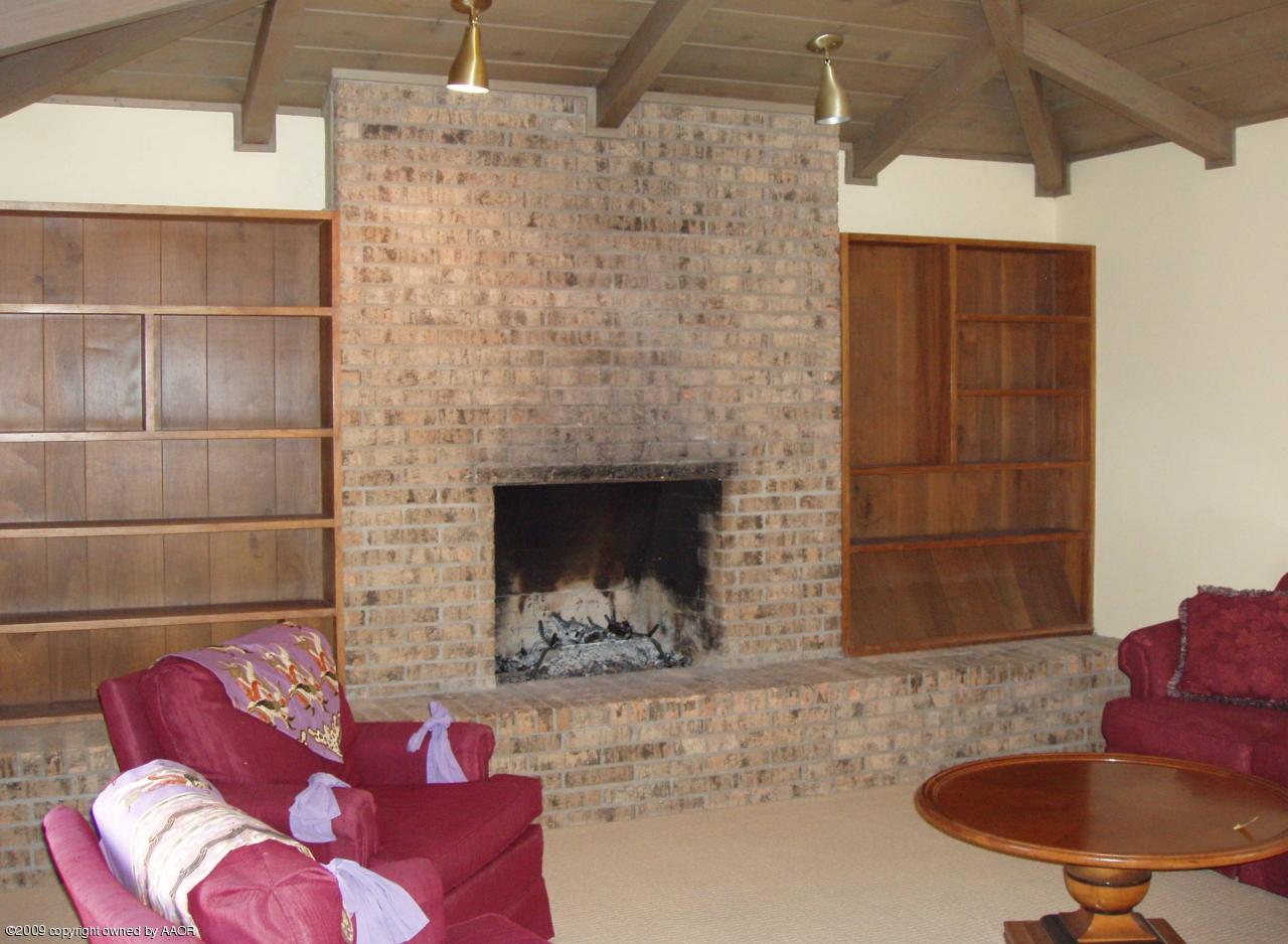 7114 Jameson Road Amarillo, TX 79106 - Photo 3 of 13 a living room with furniture and a fireplace