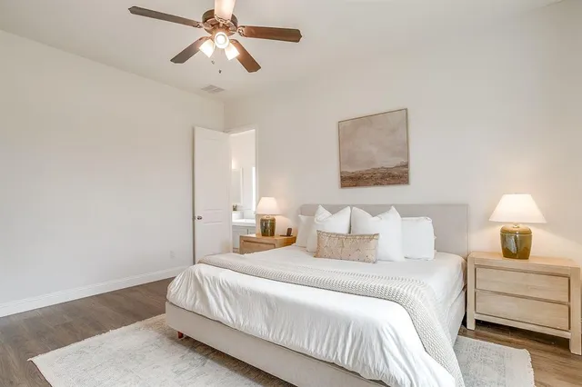 a living room with furniture a fireplace chandelier and a flat screen tv