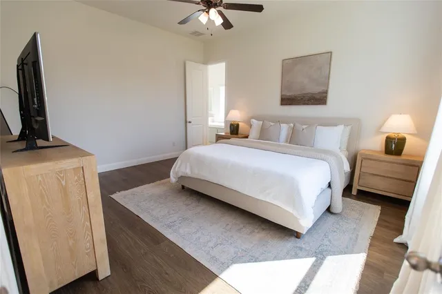 a bedroom with a bed flat screen tv and a window