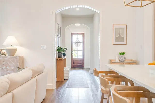 a bedroom with a bed a couch and a chandelier