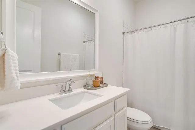 a bedroom with a bed and a night stand