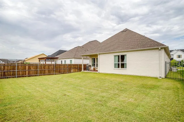 a view of an house with backyard space and balcony