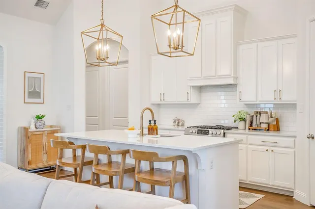 a living room with fireplace furniture and a chandelier