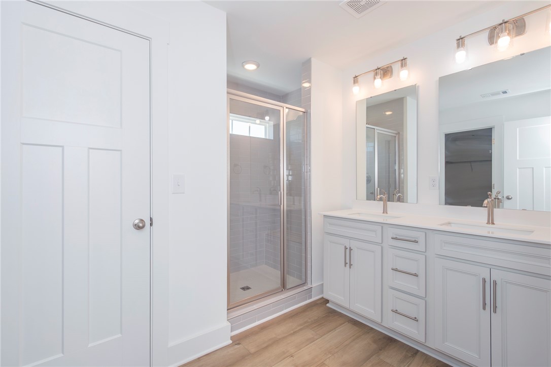607 WH Kay Lane Anderson, SC 29621 - Photo 35 of 48 Dual vanities and a spacious walk-in shower elevate this pristine bathroom.