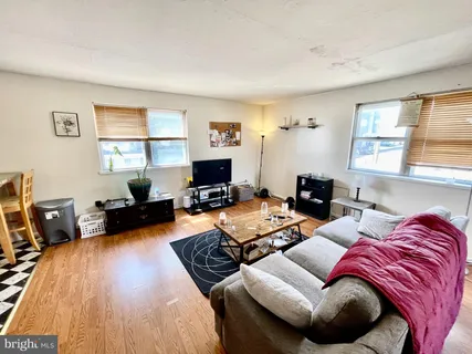 a living room with furniture a flat screen tv and a window