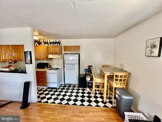 a kitchen with stainless steel appliances a refrigerator and a stove top oven