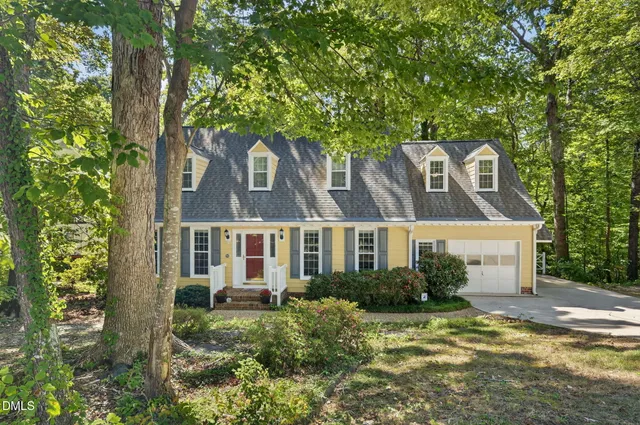 front view of a house with a tree
