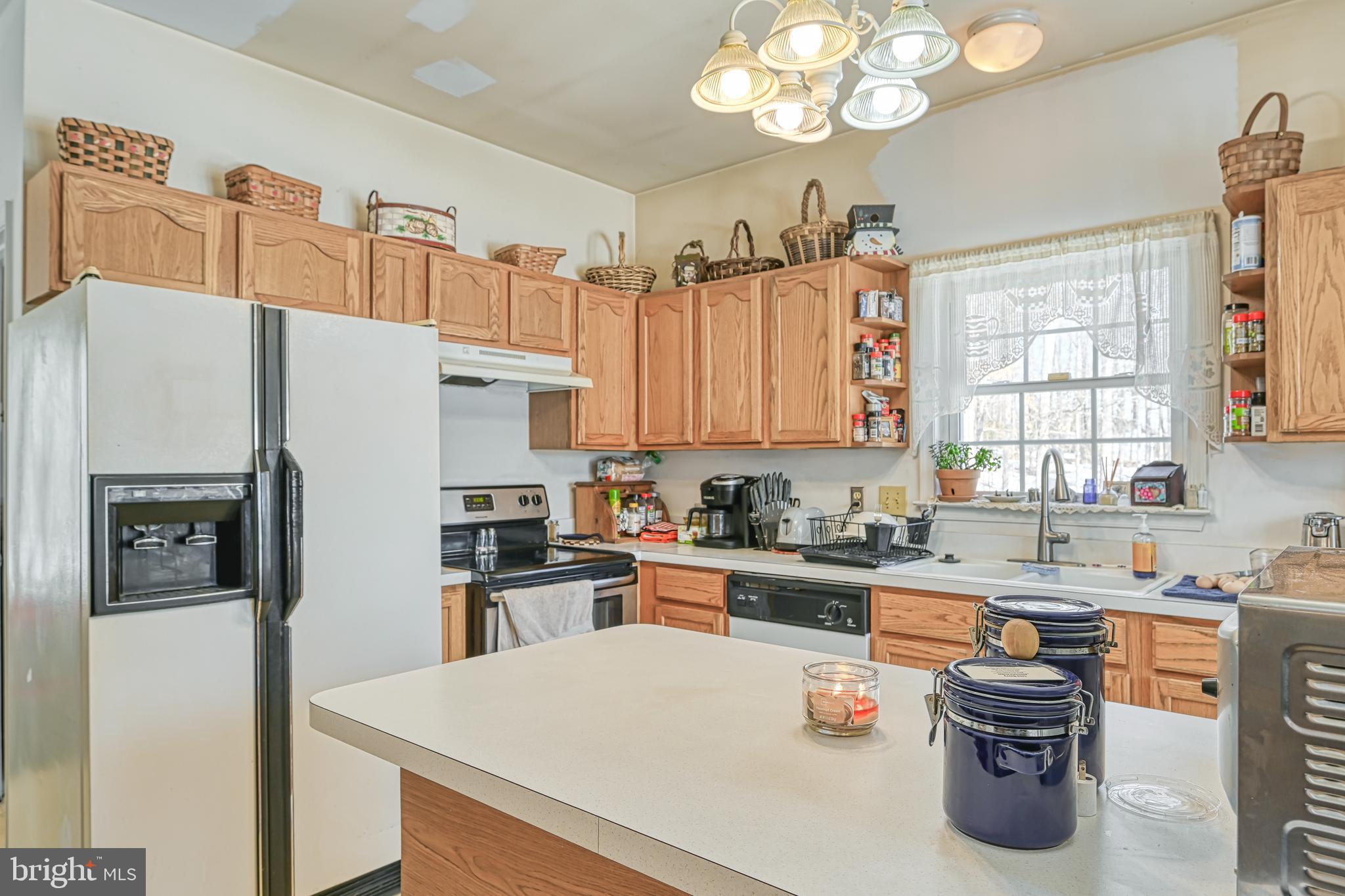 441 Hartwood Road Fredericksburg, VA 22406 - Photo 16 of 58 a kitchen with stainless steel appliances a refrigerator a sink a stove and cabinets