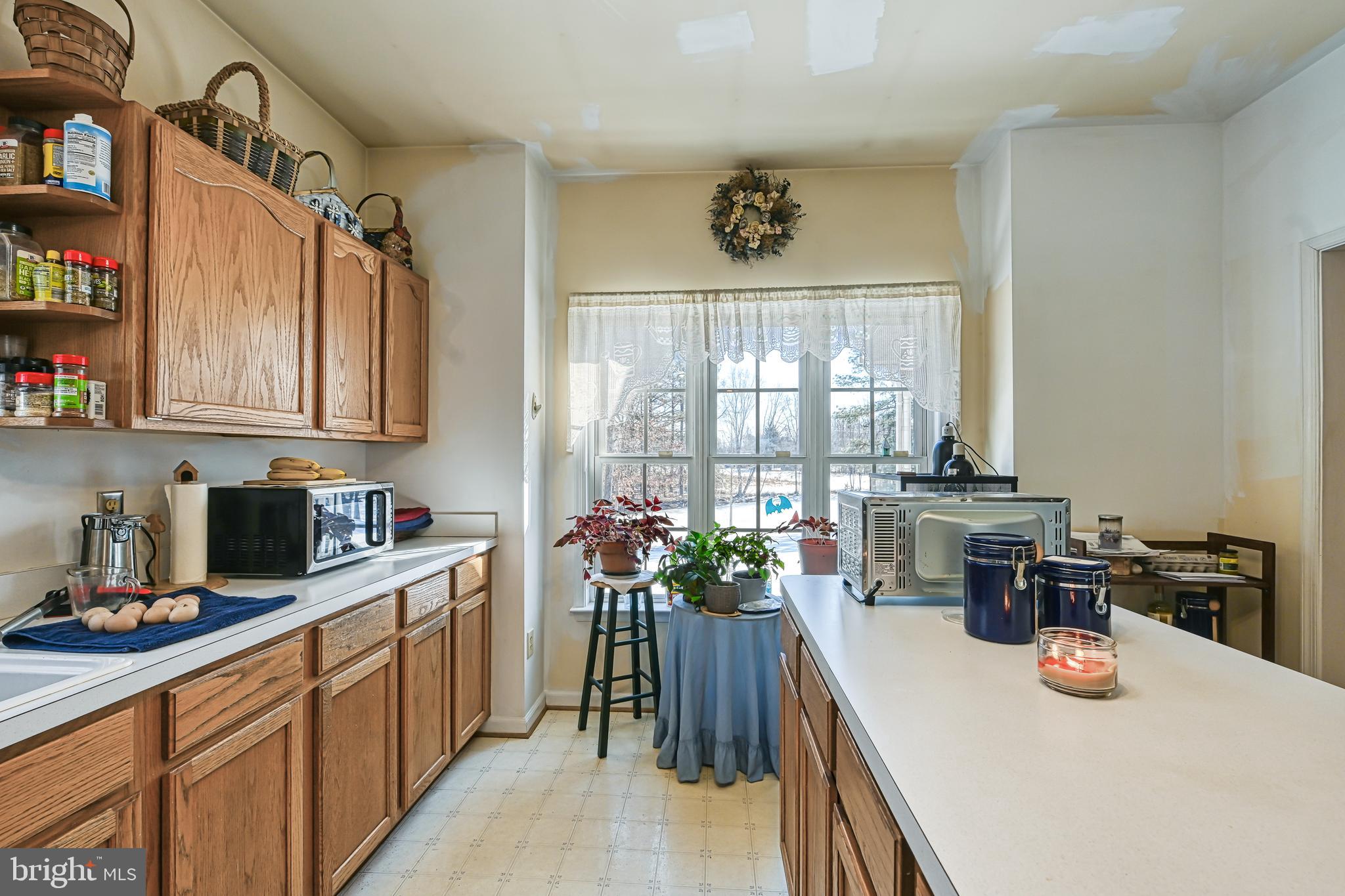 441 Hartwood Road Fredericksburg, VA 22406 - Photo 20 of 58 a kitchen with stainless steel appliances a sink a window and cabinets