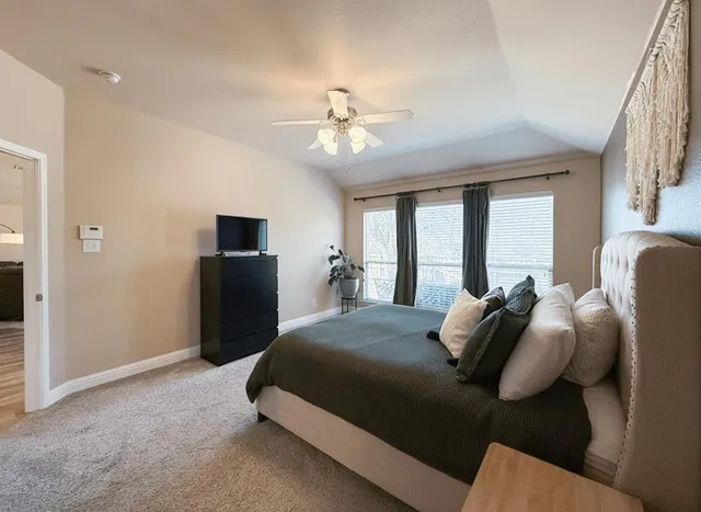 a bedroom with bed and a chandelier