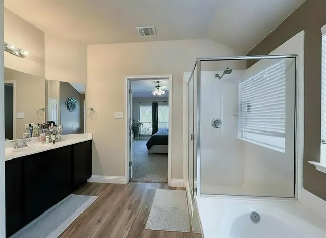 a bathroom with a sink and shower