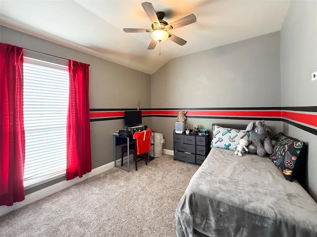 a bedroom with bed and a chandelier