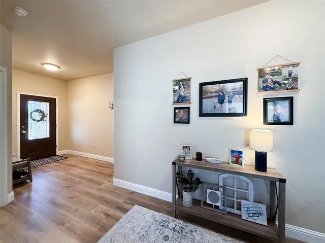 a living room with furniture and paintings on the wall