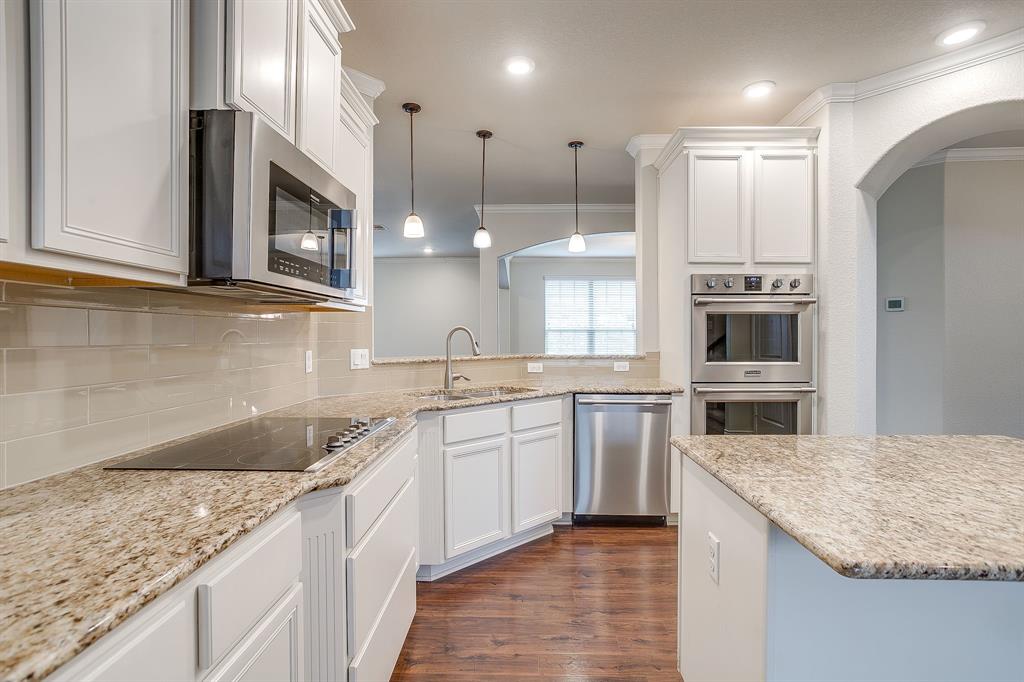 1225 Drummond Circle Waco, TX 76712 - Photo 11 of 40 a kitchen with stainless steel appliances granite countertop a sink a stove and a wooden cabinets